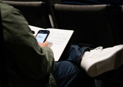 A person taking notes on their phone at the Breaking Barriers Conference 2023
